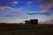 Silhouette of bitumen tanks under a sunset