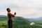 Silhouette of black african american muscular man with hands raised to beautiful mountain background. Amen Pray concept.