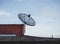 Silhouette black satellite dish on the roof.