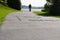 Silhouette of blurred in motion cyclists on shared pathway with sign in surface \\\