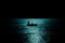 Silhouette of boat fishing in the sea in moonlight reflection reverse light