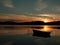 Silhouette of a boat on a lake with sunset