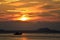 Silhouette of boat mooring at sea with sunset sky