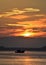 Silhouette of boat mooring at sea with sunset sky