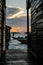 Silhouette of boats and unidentified man working early morning during sunrise.