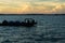 Silhouette of boats and unidentified man working early morning during sunrise in Semporna, Sabah, Malaysia