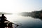 silhouette of boatsman rowing out into the yamuna ganga river in the morning