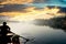 Silhouette of boatsman rowing out into the yamuna ganga river in the morning