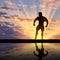 Silhouette of bodybuilder posing at sunset