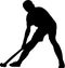 Silhouette of boy hockey player playing corner ball