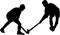Silhouette of boy hockey players battling for possession of ball