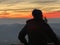 A silhouette of a boy observing landscape in sunset light. Uetliberg Zurich Switzerland in winter.