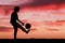 Silhouette of a boy playing football or soccer at