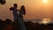 silhouette of bride hugs and kisses groom