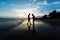 Silhouette of brothers holding hands on the beach