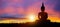 Silhouette of Buddha mediating in the twilight with sunrise background. Buddhist holiday Concept