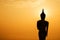 Silhouette of Buddha statue in sunset