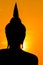 Silhouette of Buddha statue in sunset