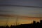 Silhouette of building with yellowish orange twilight sky in the background