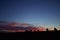 Silhouette of buildings with pinkish red twilight sky in the background