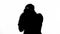 Silhouette of businessman boxing invisible opponent, protecting his business