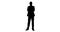 Silhouette of businessman standing with arms crossed