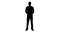 Silhouette of businessman standing with hands behind back