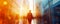Silhouette of businessman walking in sunlit corridor with reflections of the cityscape on glass walls, evoking sense of
