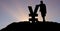 Silhouette businesswoman leaning on yen sign against sky