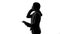 Silhouette of businesswoman talking on phone, arranging meeting, checking agenda