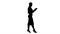 Silhouette Businesswoman using electronic tab walking.