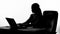 Silhouette of busy woman typing on laptop, secretary working at her job place