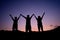 Silhouette of camping group hands up together