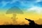 Silhouette of cannon with explosion isolated on sunset background. Cannon ball explosion background