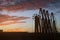 Silhouette cargo manifolds of the oil terminal in the sea port at sunset.