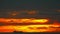 Silhouette cargo ship slow moving on horizon sea and sunset red yellow orange sky