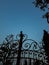 silhouette of a cast iron gate with the moon