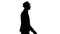 Silhouette Casual arabic man in hat walking.