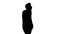 Silhouette Casual man talking on mobile phone while walking.