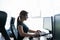 Silhouette of a caucasian business woman typing at a computer. Female employee works overtime. The girl sits at a desk