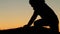 Silhouette of a Caucasian hiker in mountains at sunset