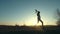 Silhouette of cheerful girl running with small toy airplane