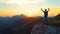 SILHOUETTE: Cheerful male hiker celebrates catching the sunset in the Alps.