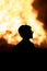 Silhouette of a child against a Lag Baomer bonfire