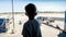 Silhouette of child looking on airplanes riding on runway at airport