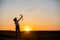 Silhouette of child playing with bow and arrows, archery shoots