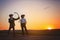 Silhouette of child playing with bow and arrows, archery shoots