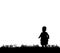 Silhouette of a child walking on grass