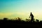 Silhouette of children cyclist riding Movement on the background