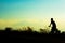 Silhouette of children cyclist riding Movement on the background